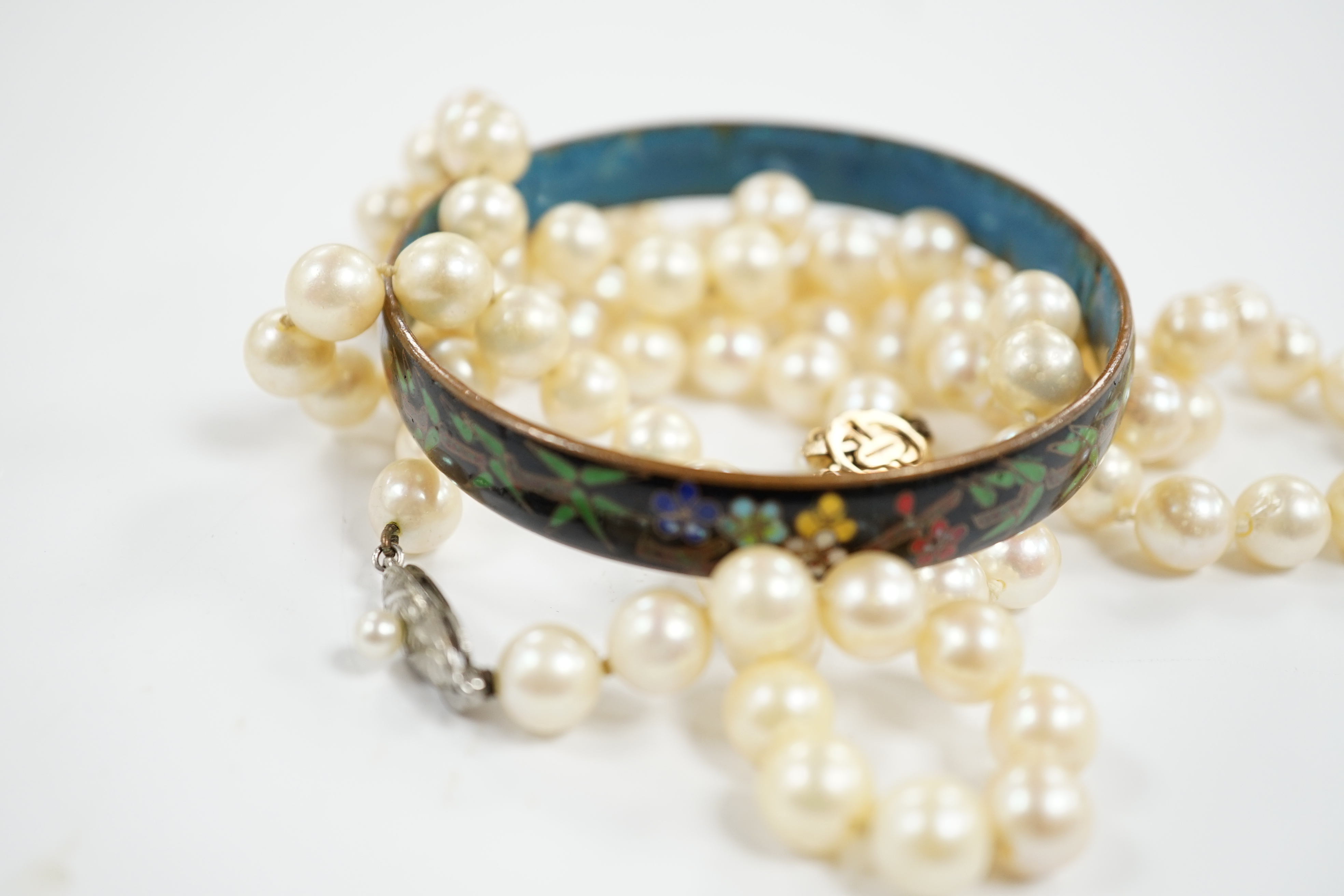 Two single strand cultured pearl necklaces, one with 9ct, white opal and cultured pearl set clasp, 40cm and a cloisonné bangle.
